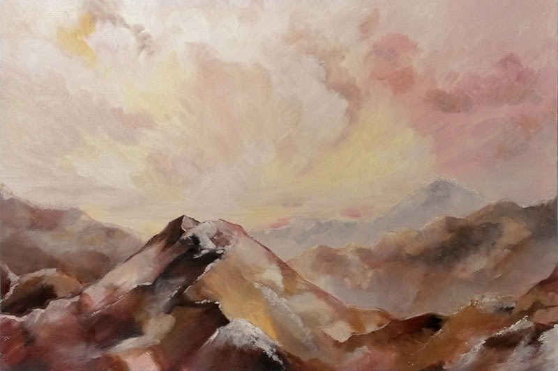 Paysage rocheux : montagnes rocheuses sous un ciel lumineux aux tons roses et jaunes.